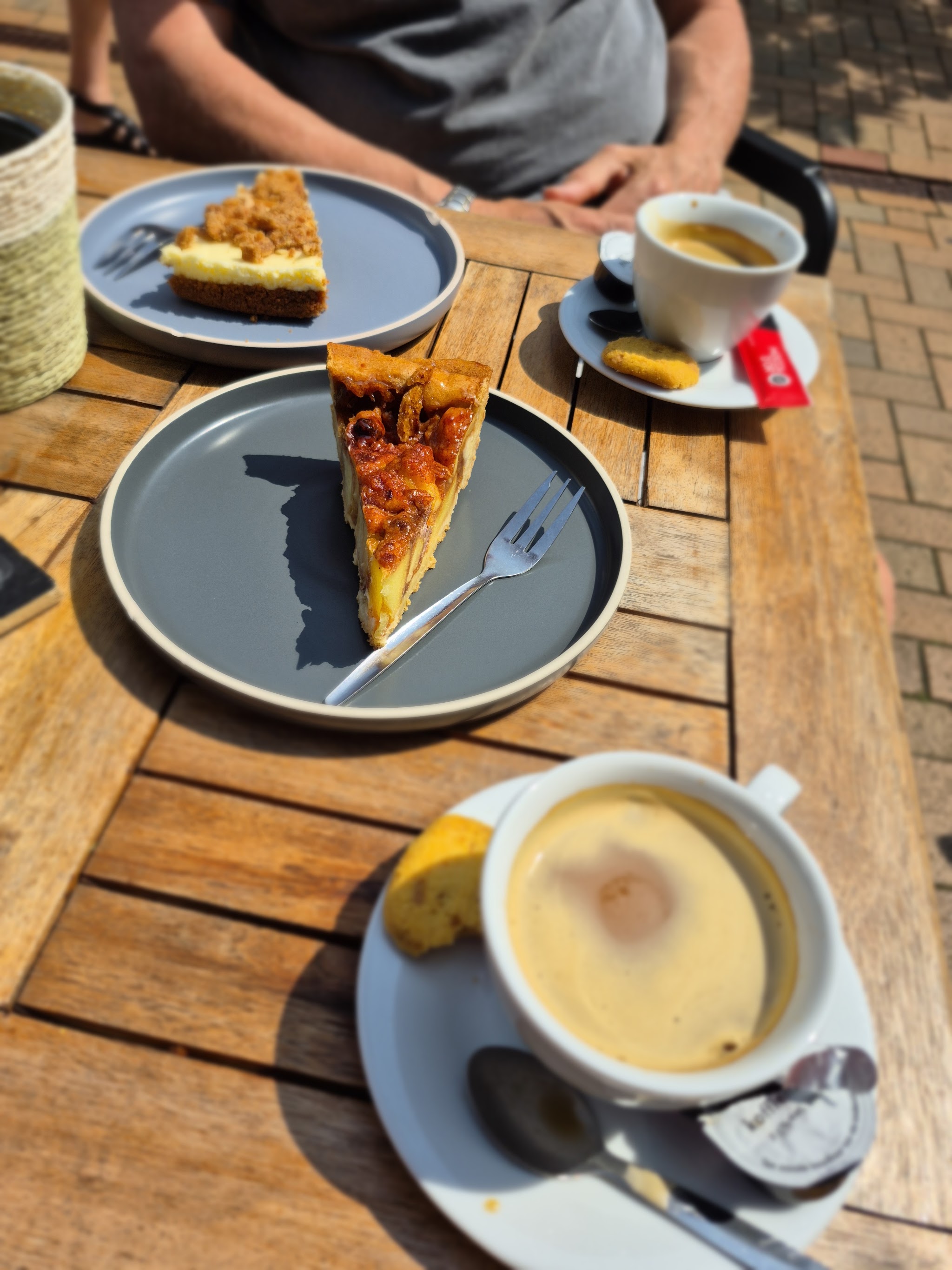 Koffie en gebak op de houten terrastafel